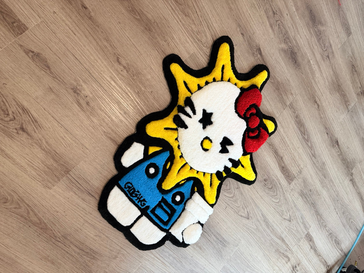 Angled view of the Hello Kitty-inspired sunburst tufted rug with red bow and blue outfit