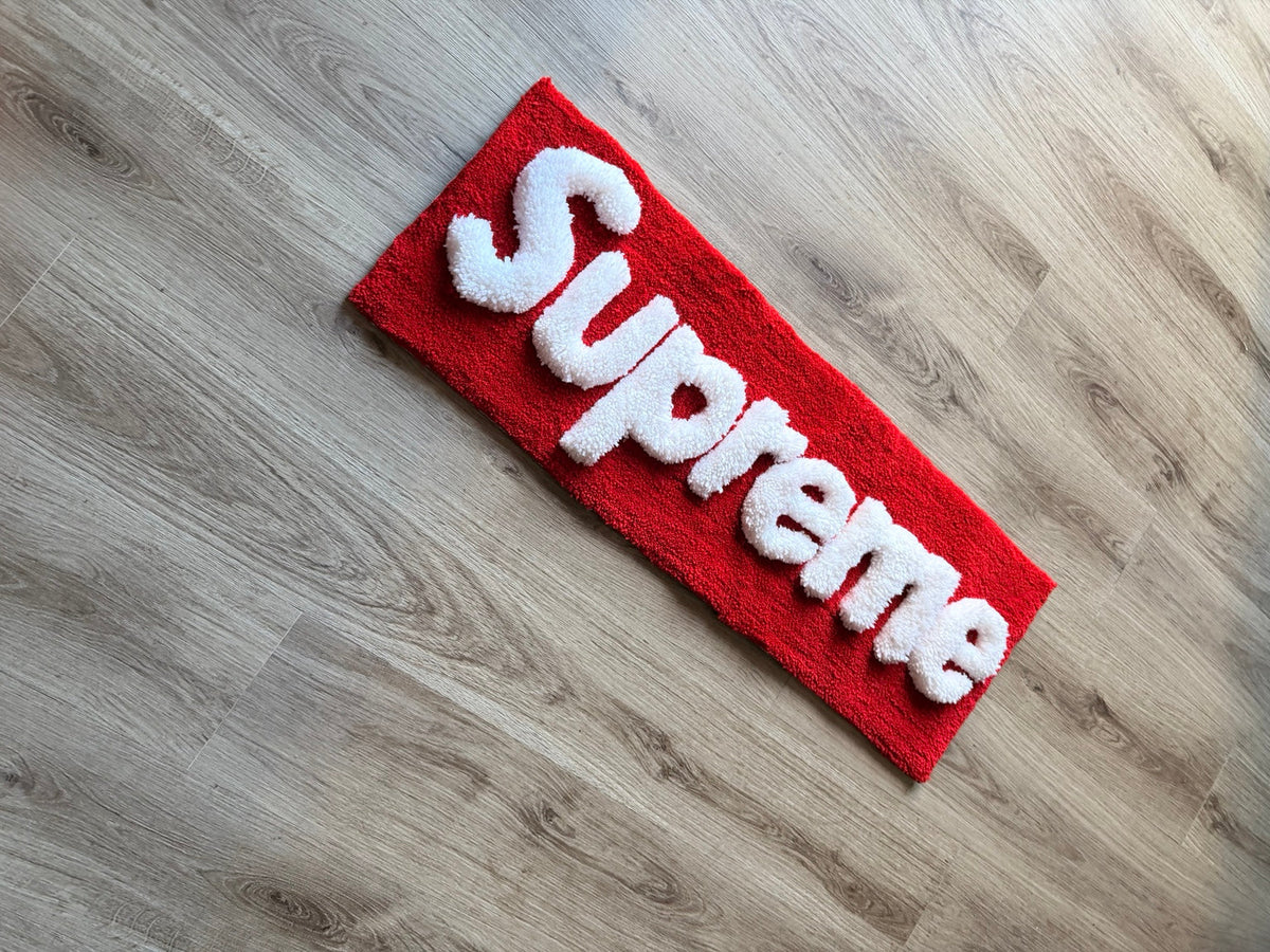 Full angled view of the red Supreme-inspired tufted rug